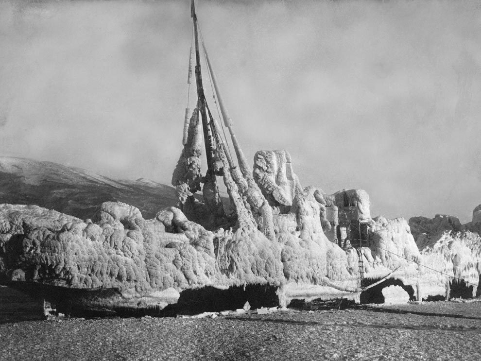 A ghost ship grounded ashore is covered in ice. Photograph by L & A Schaul.